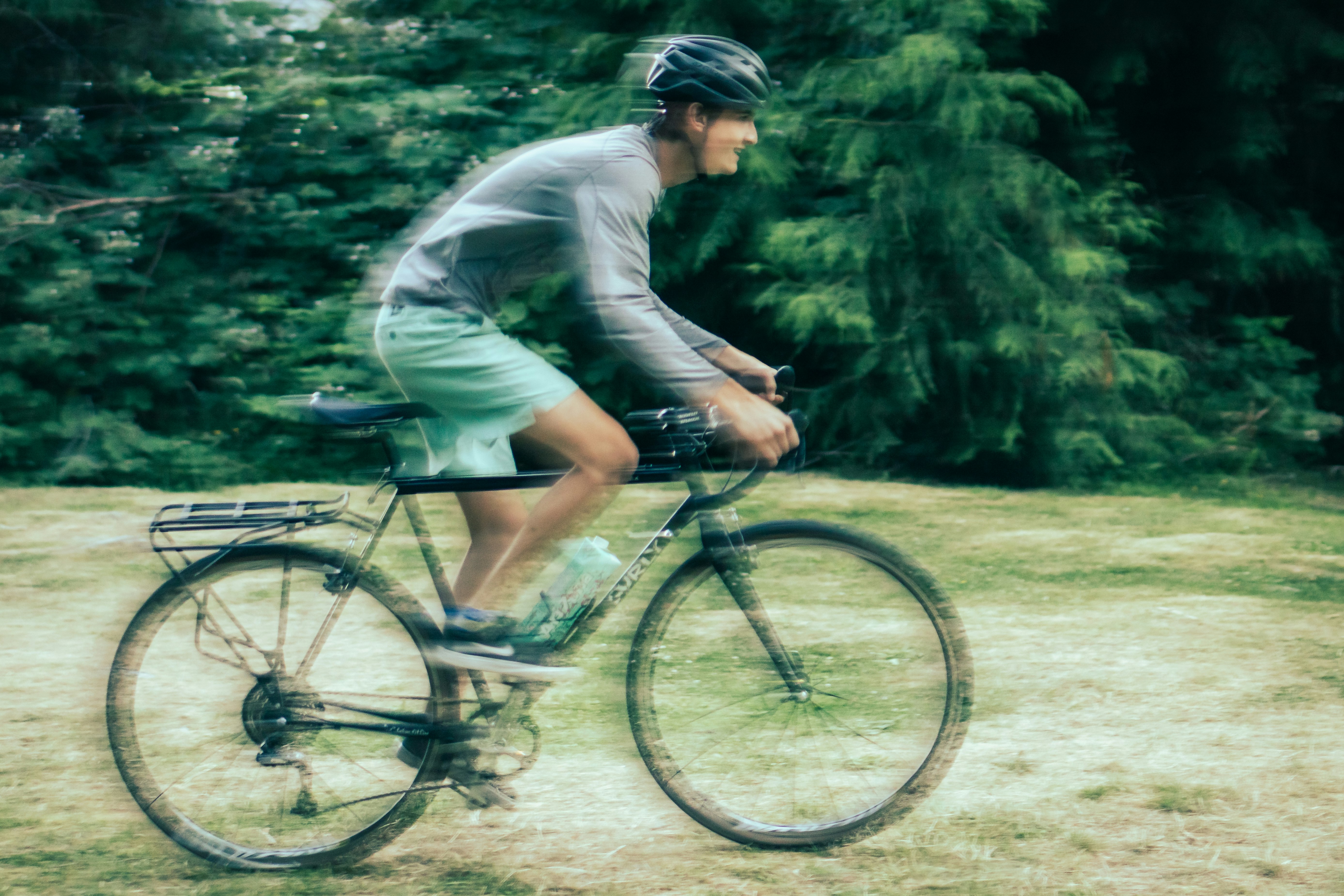 man in gray long sleeve shirt riding on bicycle